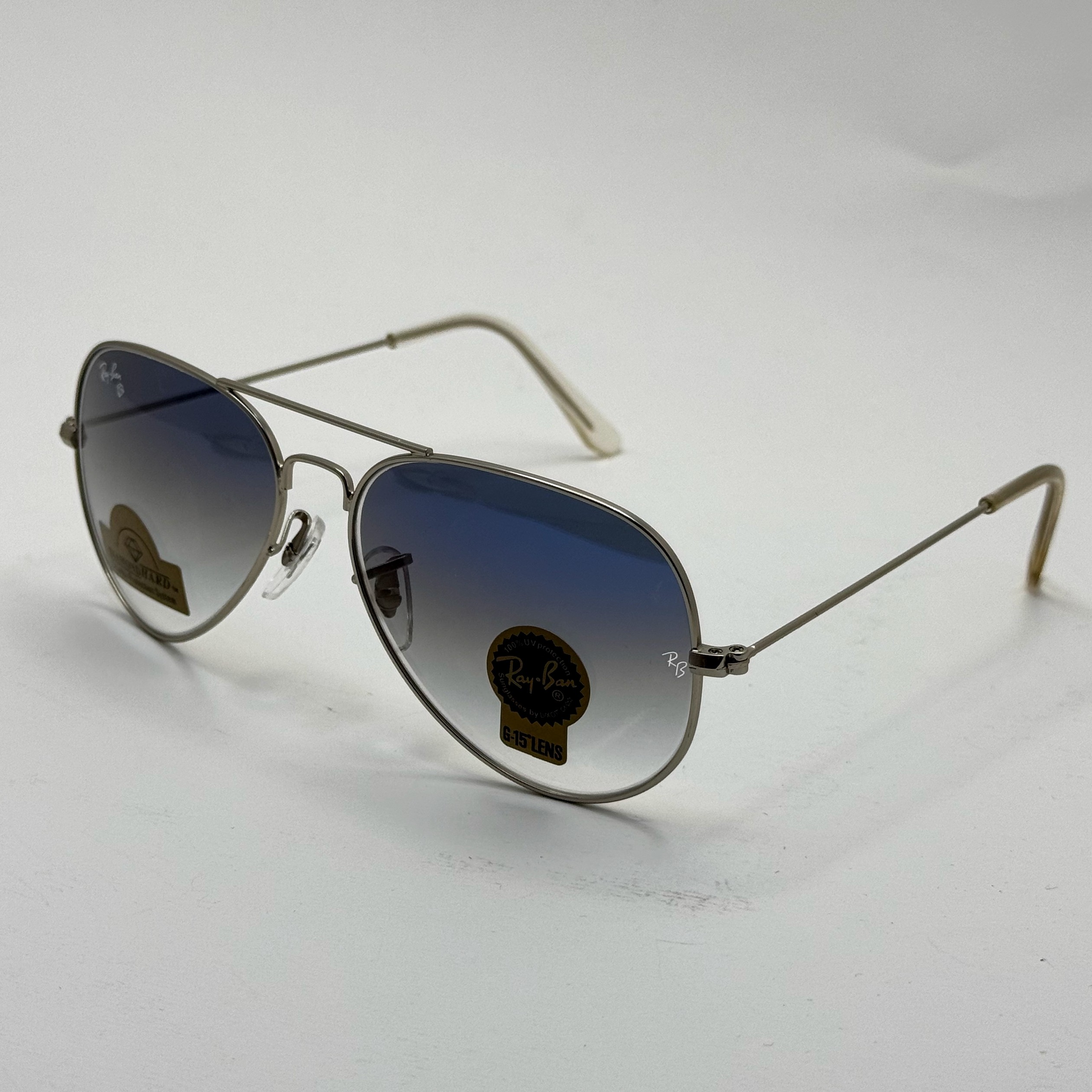 عینک ریبن خلبانی شیشه سنگ آبی هایلایت فریم نقره ای به همراه پک کامل ریبن Rayban RB 3025